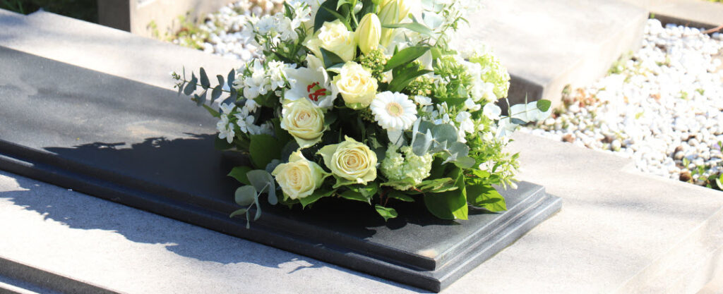 sell funeral needs online - flowers on gravesite